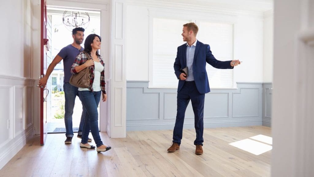 A real estate agent presenting a home to potential buyers.