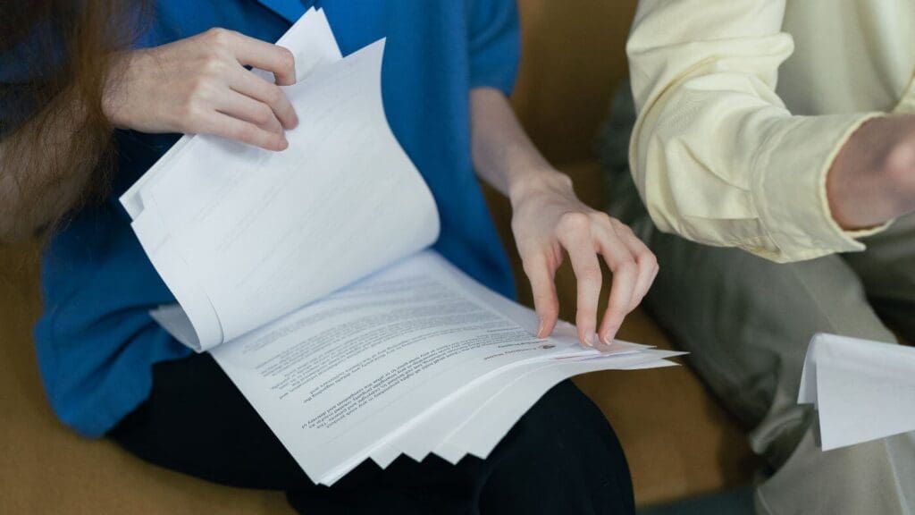 A person looking at apprasial documents with the help of a Realtor