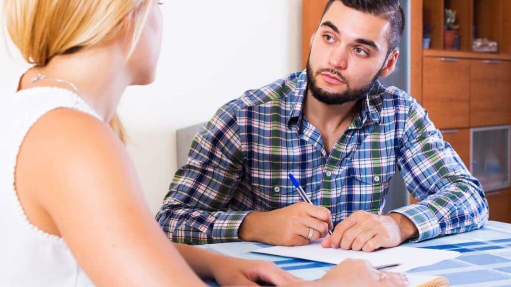 A family discussing their financial situation and minimum down payment for a house